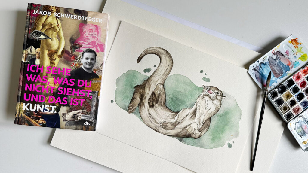 Ob der Otter aus Tuschezeichnung und Aquarell nun "Kunst" ist, überlasse ich Menschen vom Fach. Links davon liegt das Buch von Jakob Schwerdtfeger, rechts davon ein Aquarellfarbkasten und ein Pinsel.
